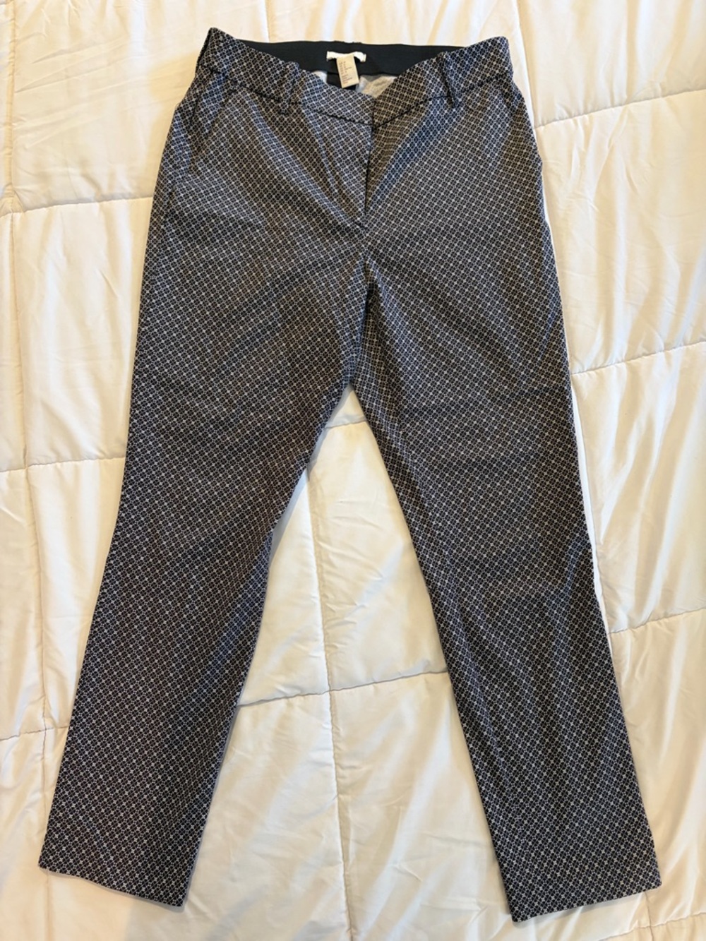 Women’s H&M￼ slim-fit dress pants in a stylish black and white micro-pattern.